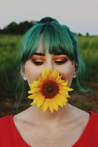 Portrait of woman with yellow flower