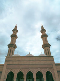 Low angle view of building against cloudy sky