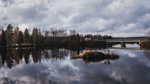 Reflection of trees in lake against sky