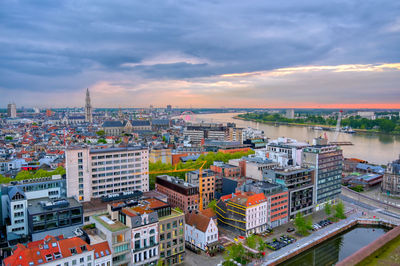 High angle view of buildings and river against sky