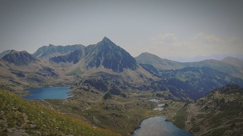 Scenic view of river and mountains against sky