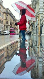 Reflection of woman in puddle