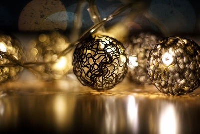 Close-up of illuminated lighting equipment on glass table