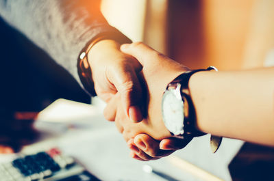 Midsection of business people doing handshake