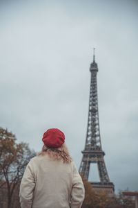 Low angle view of woman standing tower against sky