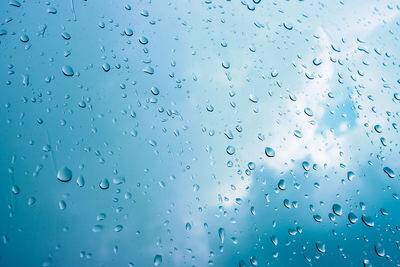 Full frame shot of raindrops on glass window