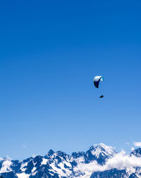 Single paraglider in the swiss alps at verbier.