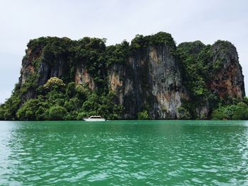 Scenic view of rocks in sea against sky