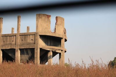 Built structure on field against sky