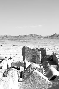 Old ruin on beach against sky