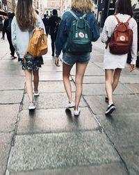 Rear view of women walking on street