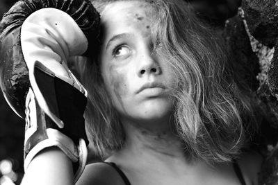 Close-up portrait of young woman looking down