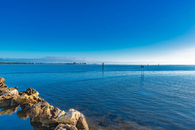 Scenic view of sea against blue sky