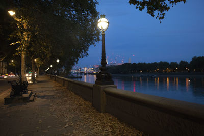 Street lights by river at night