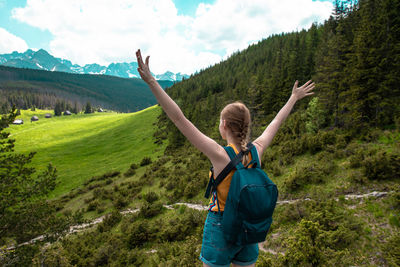 Woman tourist with hands standing cliff of rock. lifestyle travel adventure outdoor summer vacations