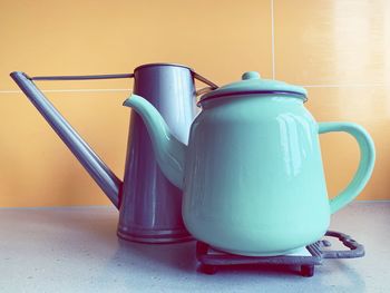 Close-up of teapot with watering can on table