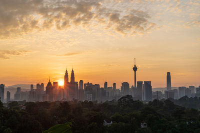 View of buildings in city during sunset