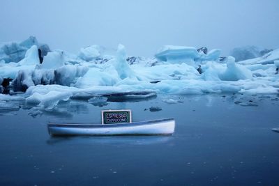 Ice floating on sea against sky