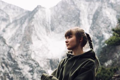 Portrait of woman looking at mountains