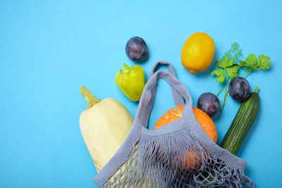 High angle view of orange fruit against blue background