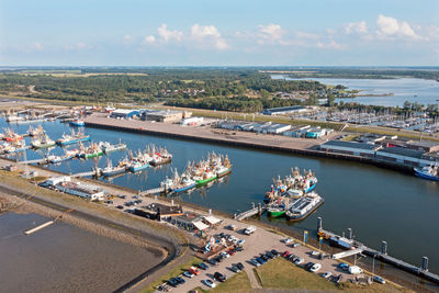 High angle view of cityscape by sea against sky