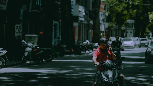 Rear view of man walking on street in city