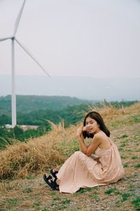 Young woman sitting on field