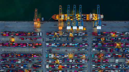 Illuminated commercial dock by building at night