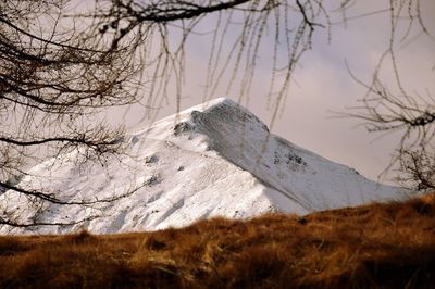 Low angle view of snowcapped mountains against sky on sunny day