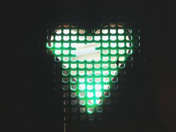 Low angle view of illuminated lamp in dark room