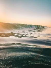 Scenic view of sea against clear sky during sunset