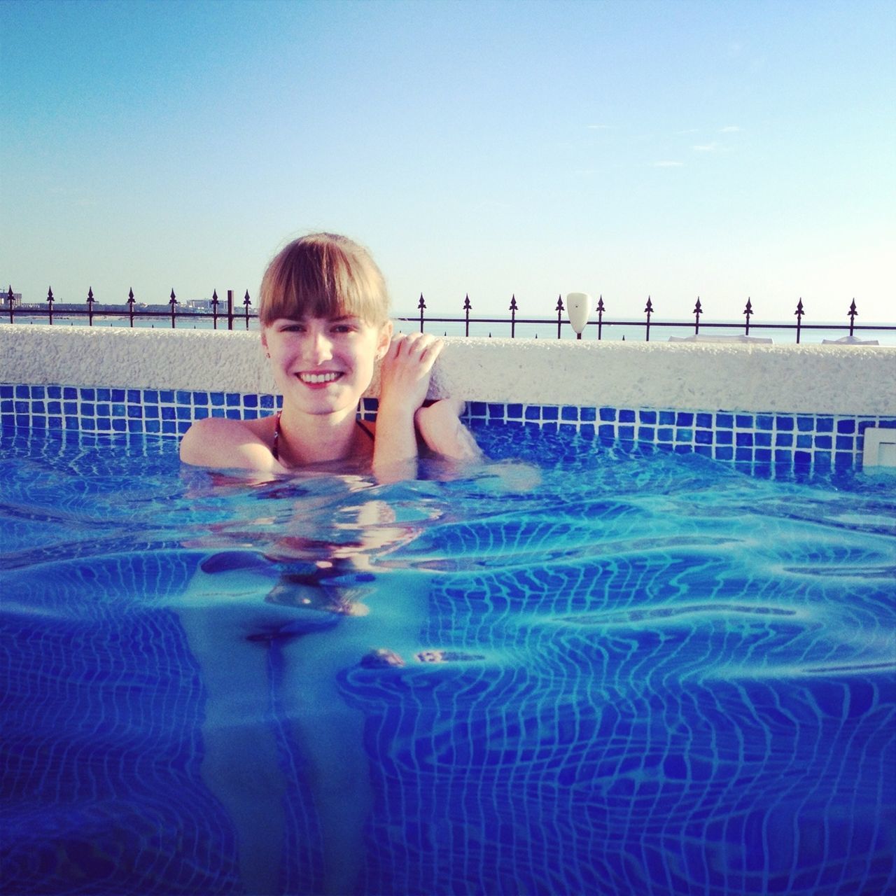 water, leisure activity, lifestyles, childhood, person, clear sky, elementary age, boys, casual clothing, blue, standing, swimming pool, front view, portrait, beach, sea, three quarter length, girls