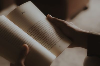 Cropped image of hand holding book