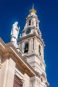 Low angle view of historic building against blue sky