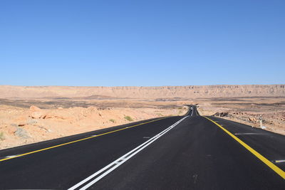 Empty road along barren landscape