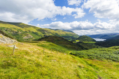 Scenic view of green landscape against sky