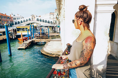 Woman standing on boat in canal