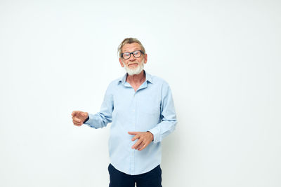 Portrait of young man standing against white background