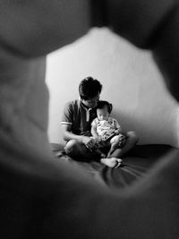 Father and son sitting on table