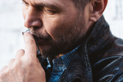 Close up portrait f man playing harmonica