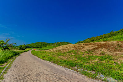 Empty road along countryside landscape