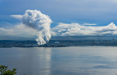 Steam rises from a factory near the port of tacoma.