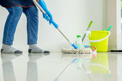 Low section of man cleaning floor 