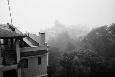 Buildings against cloudy sky