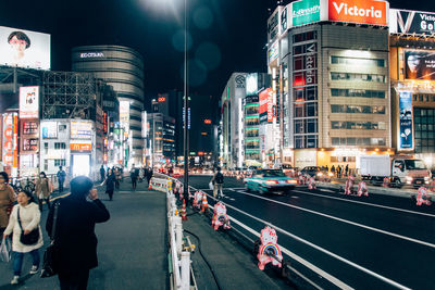 Crowd on road in city at night