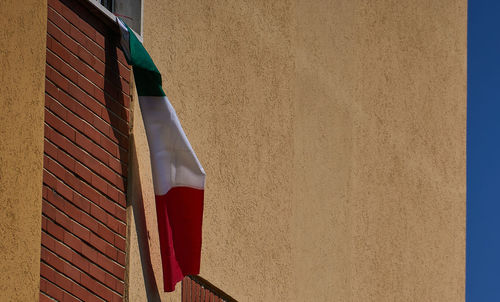 Low angle view of house hanging against wall