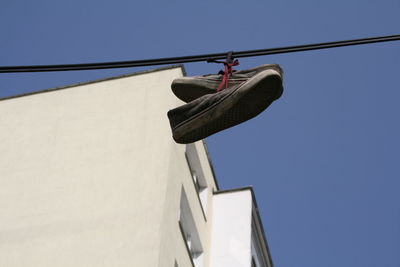 Low angle view of clothes drying against clear sky