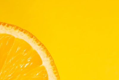 Sliced orange, yellow background, copy space. fresh juicy fruit, source of vitamin c. bright