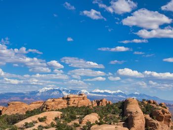 Rock formations on landscape against cloudy sky