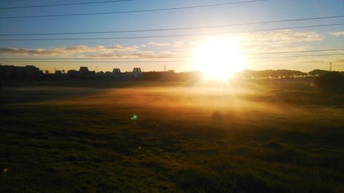 Scenic view of field against sky at sunset